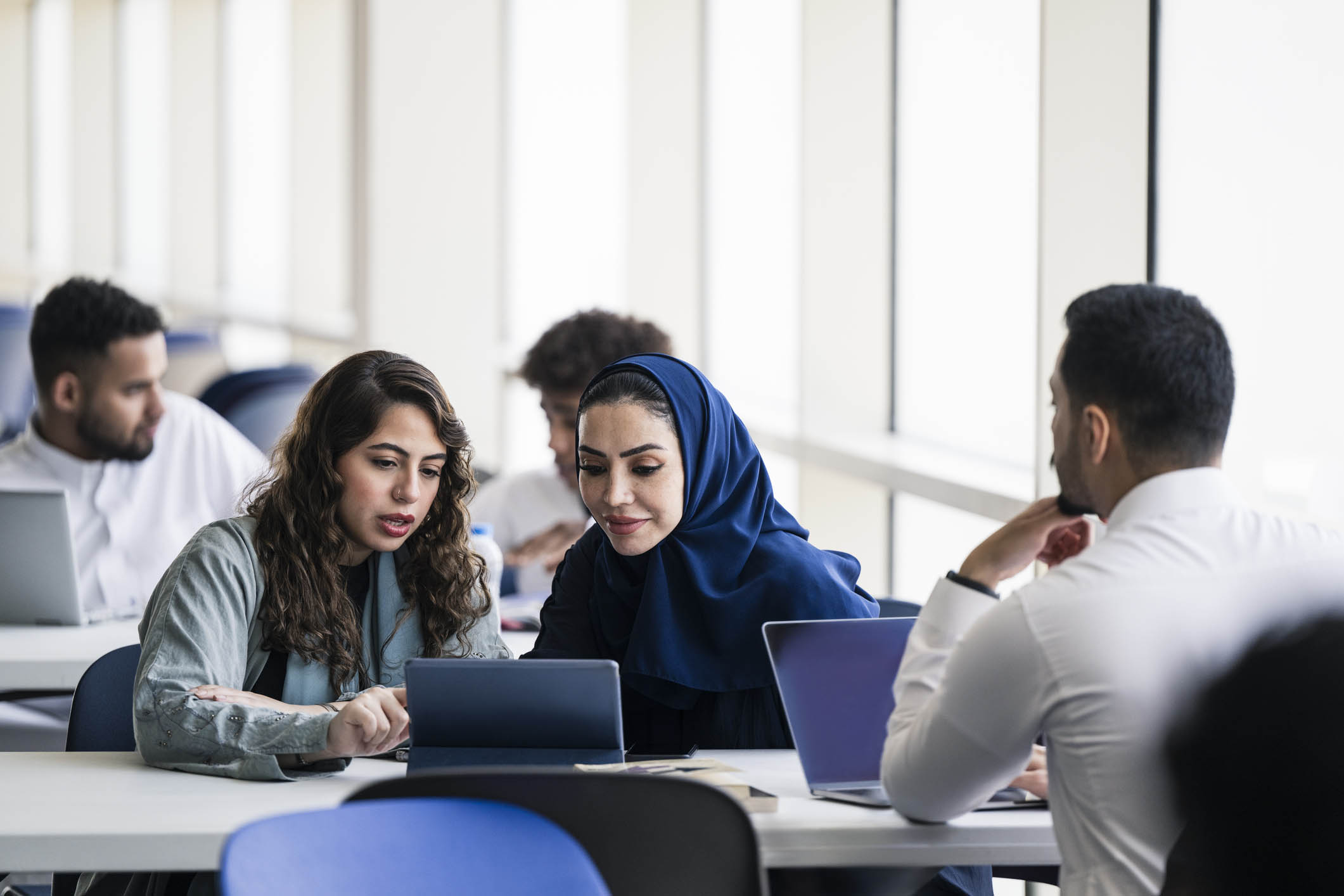 Students in group studying on laptops