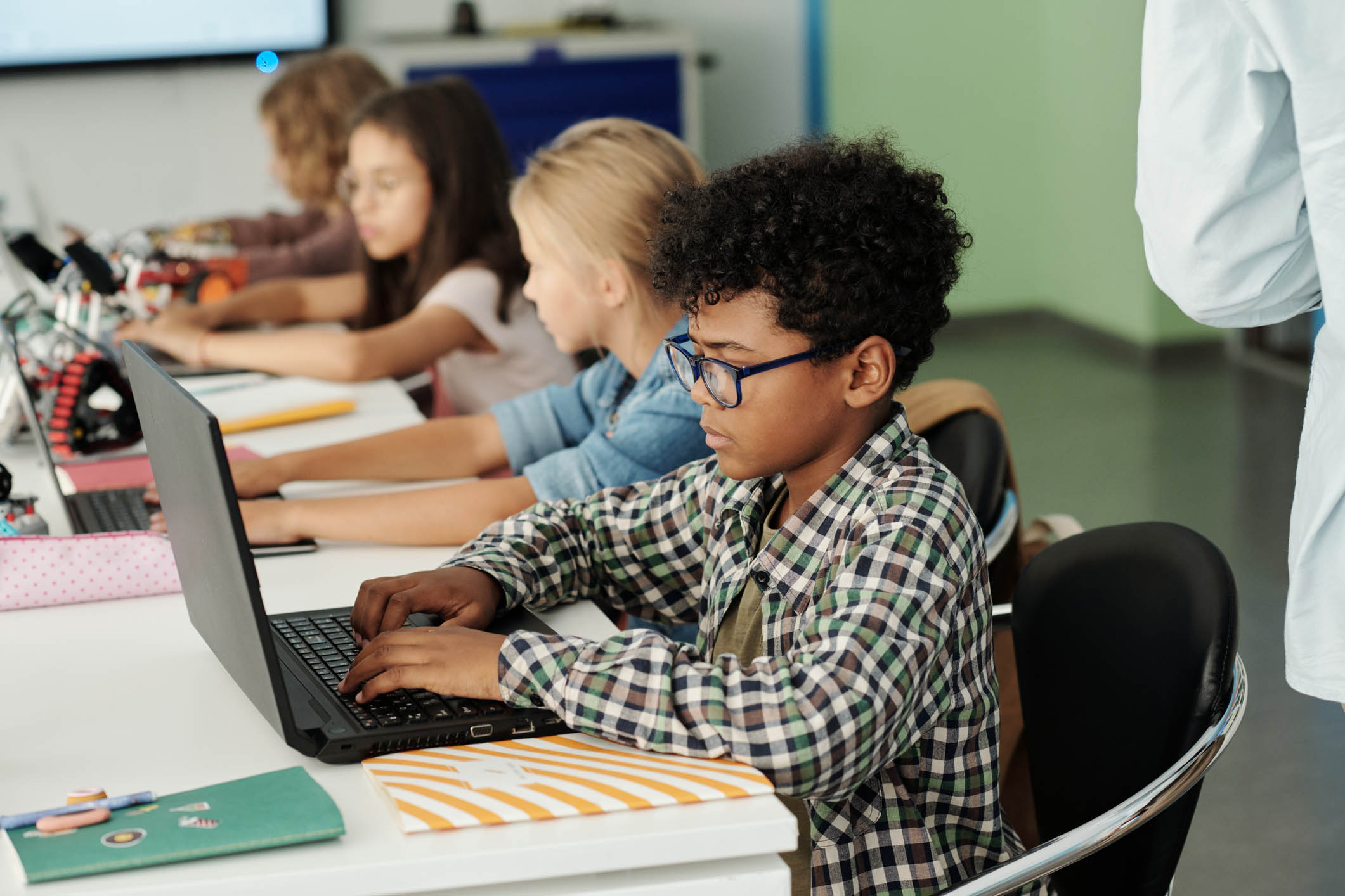 Youth in a classroom on laptops