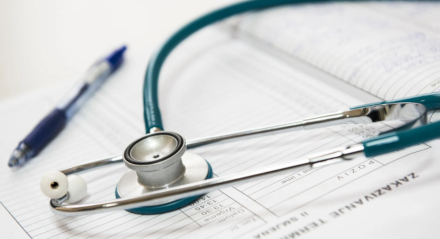 Pen and stethoscope on medical report