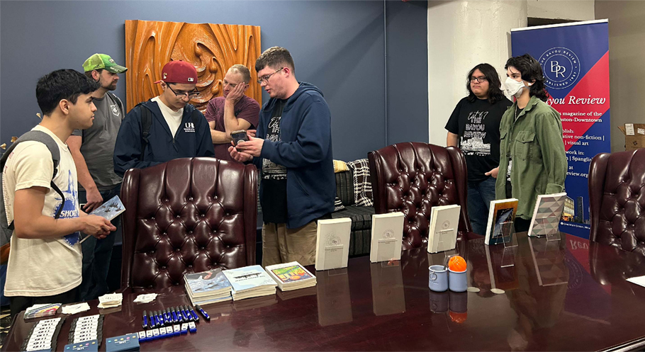 students viewing publications arranged on a conference table