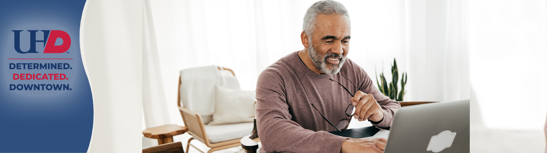 Older Adult looking at laptop Older Adult looking at laptop