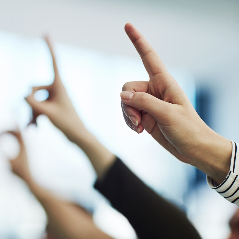 Fingers in the air requesting answers to their questions
