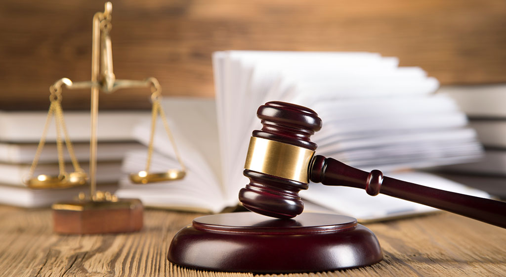 gavel with justice scales in the background