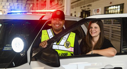 Two Public Service Servants at a Police Car