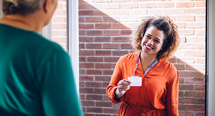 Social Worker at the front door of a home visit