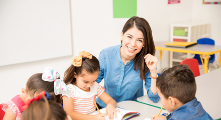 Teacher in classroom smiling