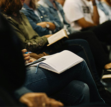 people taking notes in an event