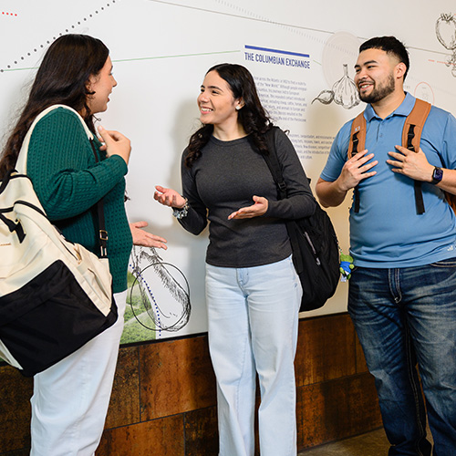 Group of UHD Students having a conversation in the hallway.