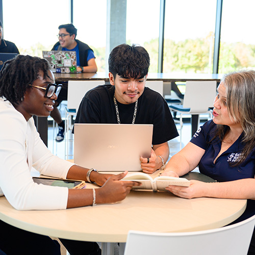 Group of UHD Students working together at a table.