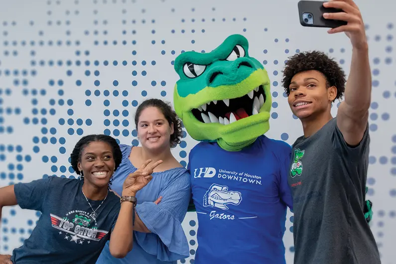 Three UHD students taking a selfie with Ed-U-Gator