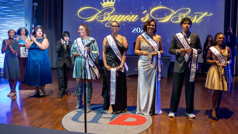 Students lined up on stage in evening wear