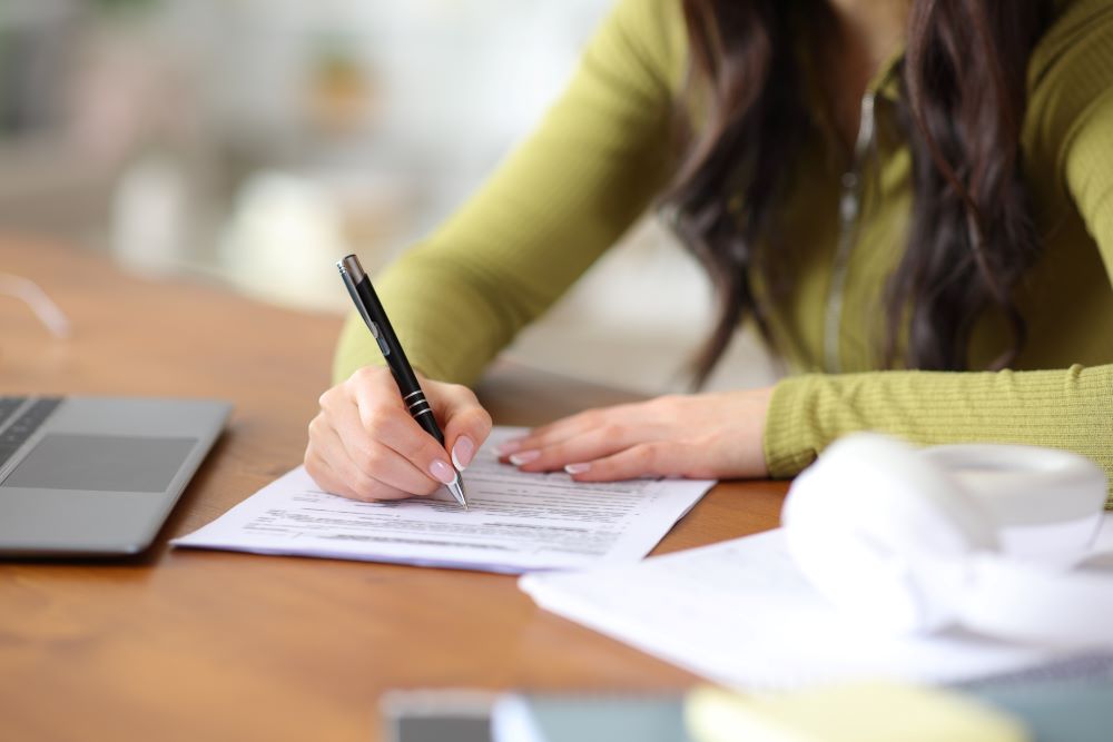 Student signing documents