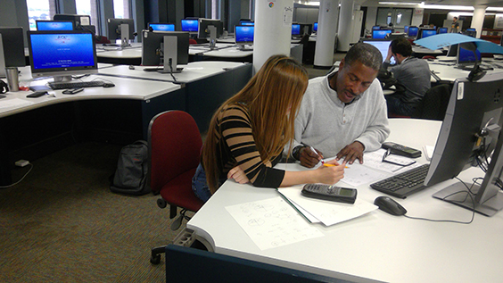 A tutor teaching a student Tutoring session at computer stations in the Academic Support Center