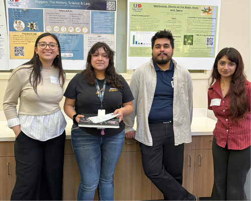 Four organic chemistry students smile at a drug awareness presentation at Nimitz High School in Houston, Texas
