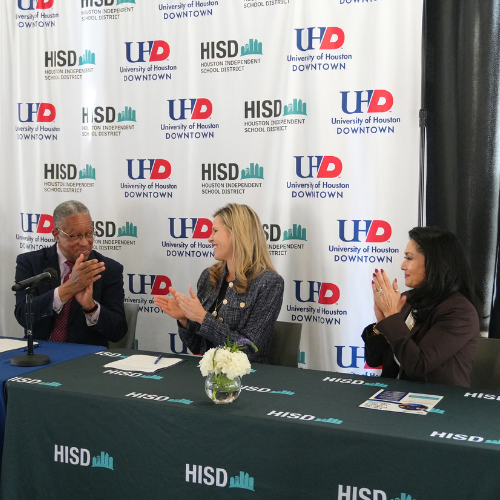 president loren j blanchard applauds aside houston independent school district's chief academic officer kristen hole and university of houston-downtown alumna and hisd board member paula mendoza at the university's mou signing at the university of houston-downtown