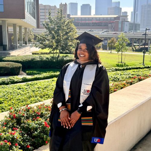 University of Houston-Downtown alumna and women's volleyball player Quanisha Vaughn wears graduation regalia at the university of houston-downtown