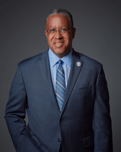 Loren Blanchard President of the University of Houston Downtown smiles in a suit and tie