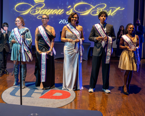 Five students at the university of houston-downtown wear sashes at the university of houston-downtown's bayou's best showcase