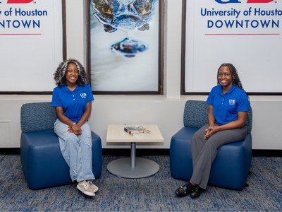 Two gator crew ambassadors and transfer students smile at the university of houston-downtown