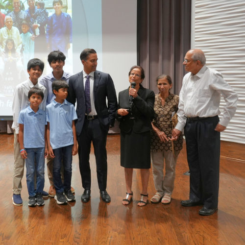 sangeeta gad speaks into a microphone while standing next to family members during the houston prep career and engineering day at the university of houston-downtown