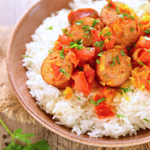 Sausage, rice, and herb garnish in a bowl