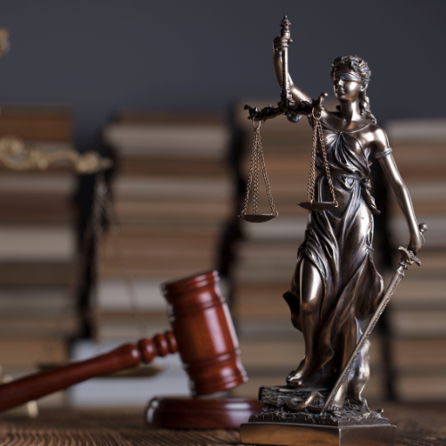 Gavel, lady justice, and a stack of books
