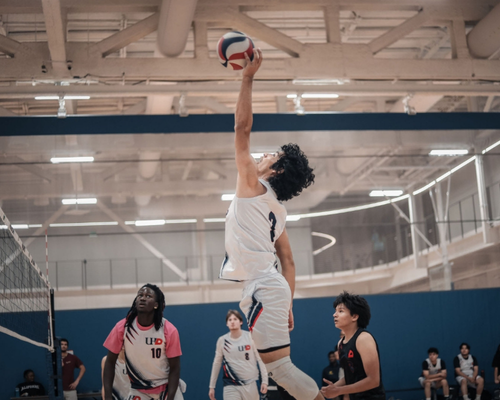 Students on men's volleyball team play a match at the wellness and success center