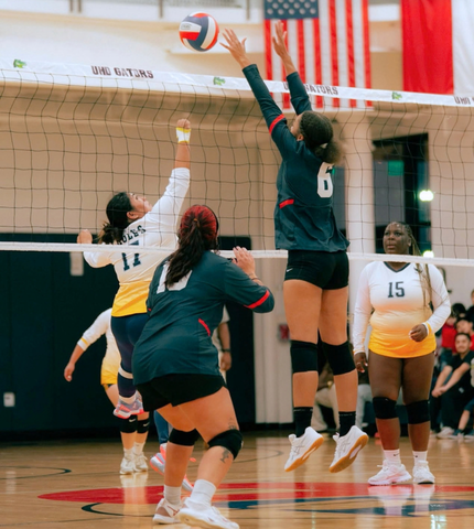 A volleyball player jumps for a volleyball during a match at the university of houston-downtown