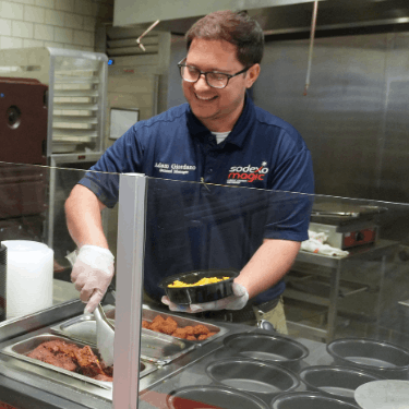 Sodexomagic staff makes a kalamata bowl at the uhd food court
